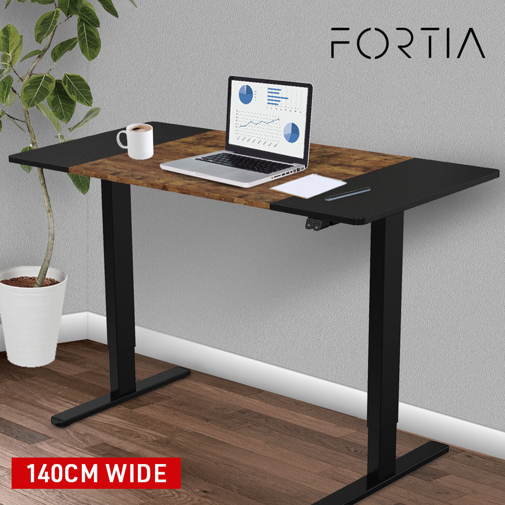 Fortia Sit To Stand Up Standing Desk, 140x60cm, 72-118cm Electric Height Adjustable, 70kg Rated, Oak Style/Black Frame